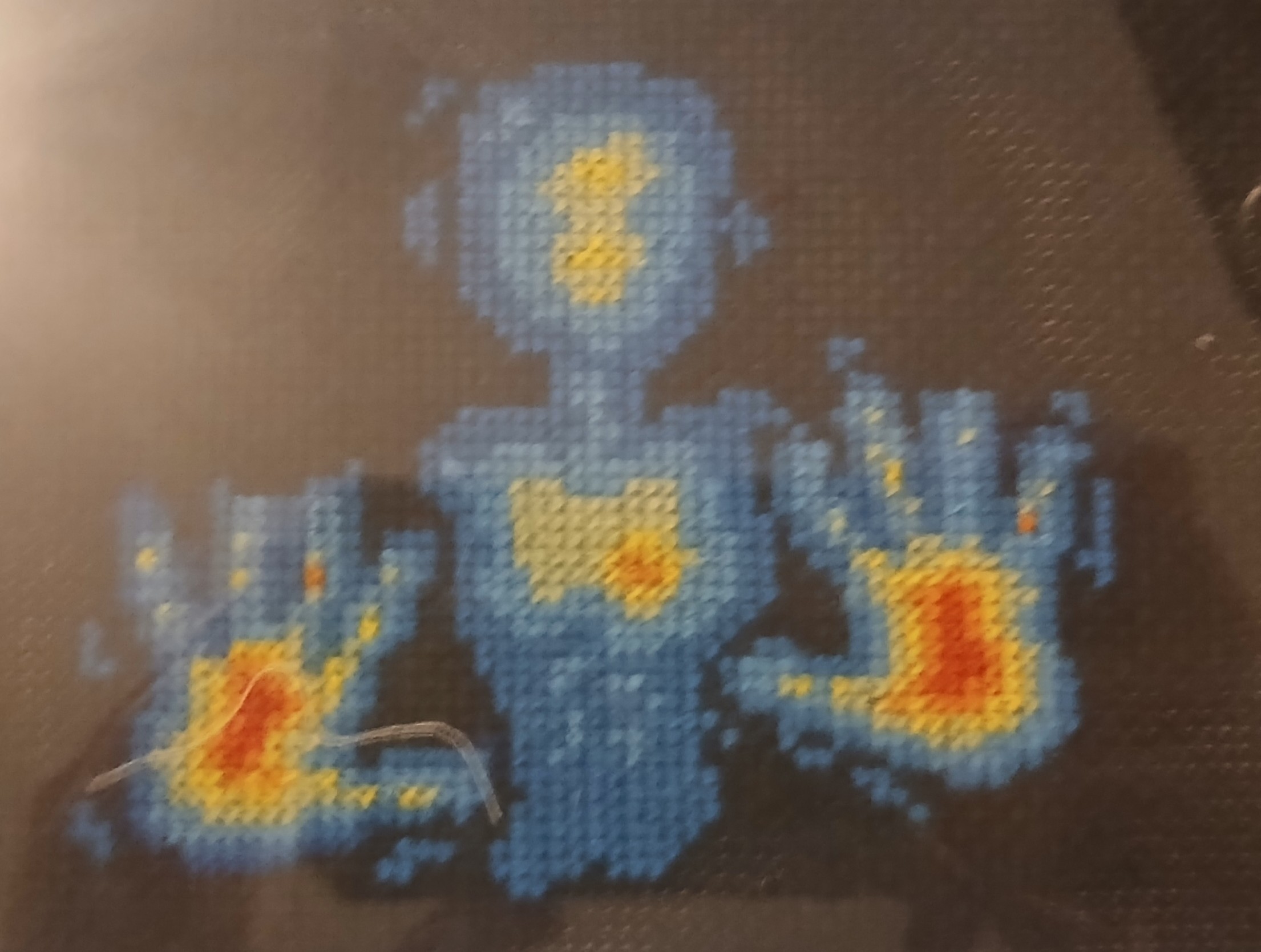 A cross stitch of a thermal camera image