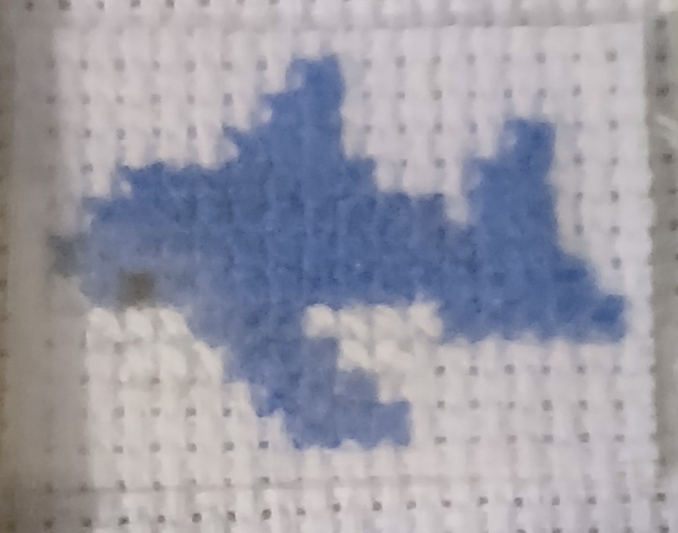 A cross stitch of a shark