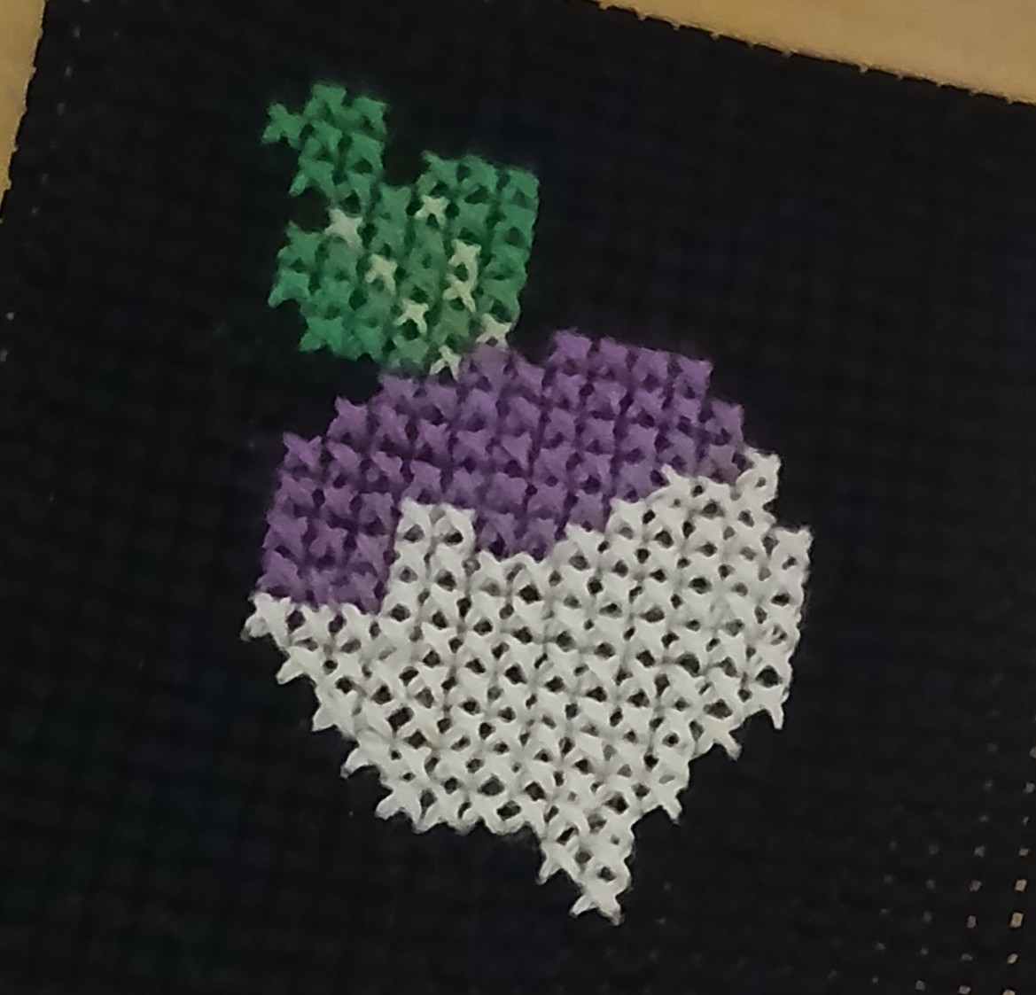 A cross stitch of a turnip